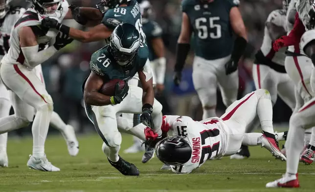 Atlanta Falcons safety Justin Simmons (31) stops Philadelphia Eagles running back Saquon Barkley (26) during the second half of an NFL football game Monday, Sept. 16, 2024, in Philadelphia. (AP Photo/Matt Rourke)