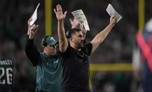 Philadelphia Eagles head coach Nick Sirianni and Kellen Moore, offensive coordinator react to a two-point conversion by Eagles running back Saquon Barkley during the second half of an NFL football game against the Atlanta Falcons on Monday, Sept. 16, 2024, in Philadelphia. (AP Photo/Matt Slocum)