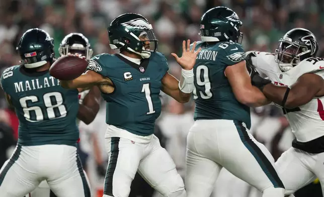 Philadelphia Eagles quarterback Jalen Hurts (1) looks to pass during the first half of an NFL football game against the Atlanta Falcons on Monday, Sept. 16, 2024, in Philadelphia. (AP Photo/Matt Slocum)