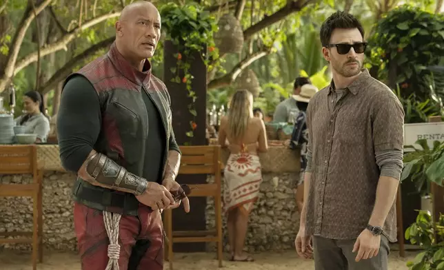 This image released by Amazon Prime shows Dwayne Johnson, left, and Chris Evans in a scene from "Red One." (Amazon Prime via AP)