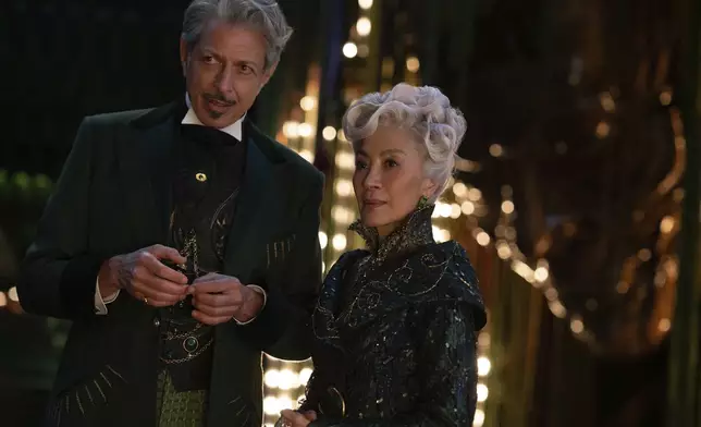 This image released by Universal Pictures shows Jeff Goldblum as The Wizard of Oz, left, and Michelle Yeoh as Madam Morrible in a scene from the film "Wicked." (Universal Pictures via AP)