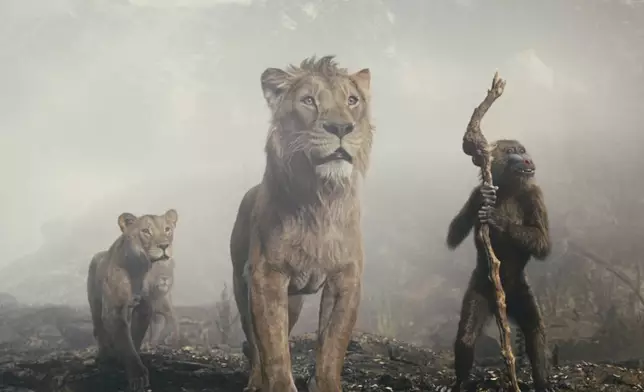 This image released by Disney shows characters Mufasa, voiced by Aaron Pierre, center, and Rafiki, voiced by Kagiso Lediga, right, in a scene from "Mufasa: The Lion King." (Disney via AP)