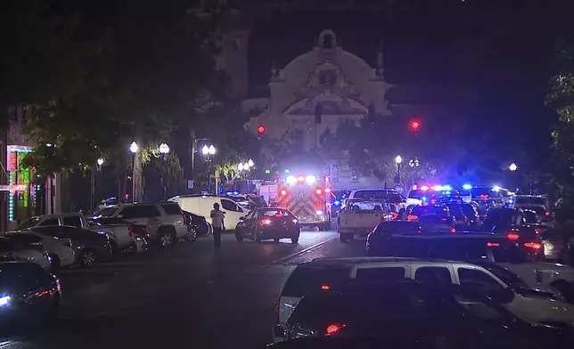 This image provided by WBMA shows police and emergency vehicles in the entertainment district after a shooting in Birmingham, Ala., Sunday, Sept. 22, 2024. (Bill Castle/WBMA via AP)