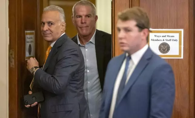 Former NFL quarterback Brett Favre, center, arrives to appear before the House Committee on Ways and Means on Capitol Hill, Tuesday, Sept. 24, 2024, in Washington. (AP Photo/Mark Schiefelbein)