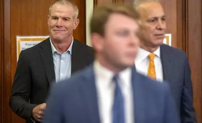 Former NFL quarterback Brett Favre, left, arrives to appear before the House Committee on Ways and Means on Capitol Hill, Tuesday, Sept. 24, 2024, in Washington. (AP Photo/Mark Schiefelbein)