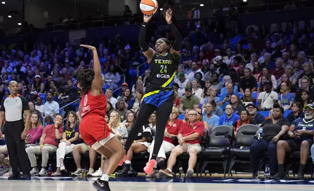 Dallas Wings guard Arike Ogunbowale takes a shot as Indiana Fever's Kelsey Mitchell (0) defends in the second half of a WNBA basketball game Sunday, Sept. 1, 2024, in Arlington, Texas. (AP Photo/Tony Gutierrez)