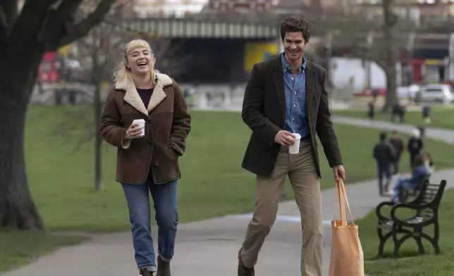 This image released by A24 shows Florence Pugh, left, and Andrew Garfield in a scene from "We Live In Time." (A24 via AP)