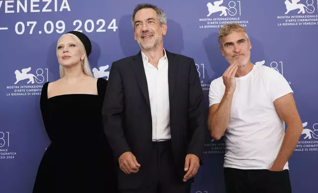 FILE - Lady Gaga, from left, director Todd Phillips, and Joaquin Phoenix pose for photographers at the photo call for the film "Joker: Folie A Deux" during the 81st edition of the Venice Film Festival in Venice, Italy, on Sept. 4, 2024. (Photo by Vianney Le Caer/Invision/AP, File)