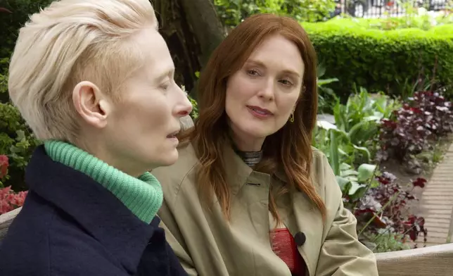 This image released by Sony Pictures Classics shows Julianne Moore, right, and Tilda Swinton in a scene from "The Room Next Door." (Sony Pictures Classics via AP)