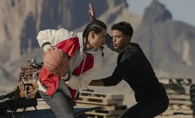 This image released by Netflix shows Kusem Goodwind as Nataanii, left, and Kauchani Bratt as Jimmy, in a scene from the film "Rez Ball." (Lewis Jacobs/Netflix via AP)