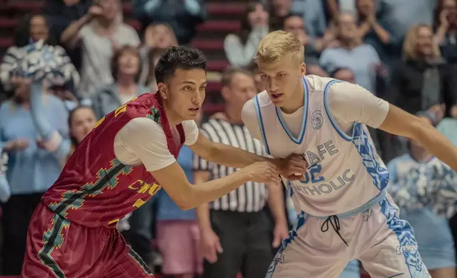 This image released by Netflix shows Kauchani Bratt as Jimmy, left, and Sam Griesel as Mason, in a scene from the film "Rez Ball." (Lewis Jacobs/Netflix via AP)