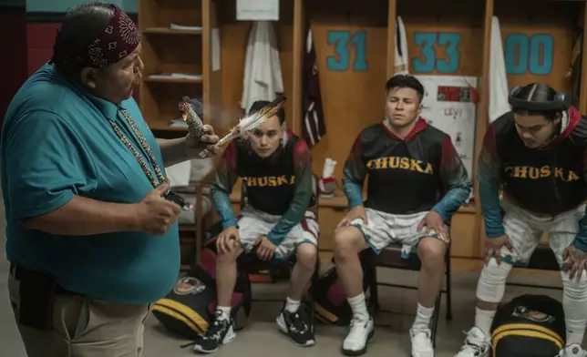 This image released by Netflix shows, from left, Ernest David Tsosie as Benny, Jaren K Robledo as Levi, Devin Sampson-Craig as Bryson and Damian Castellane as Ruckus, in a scene from the film "Rez Ball." (Lewis Jacobs/Netflix via AP)