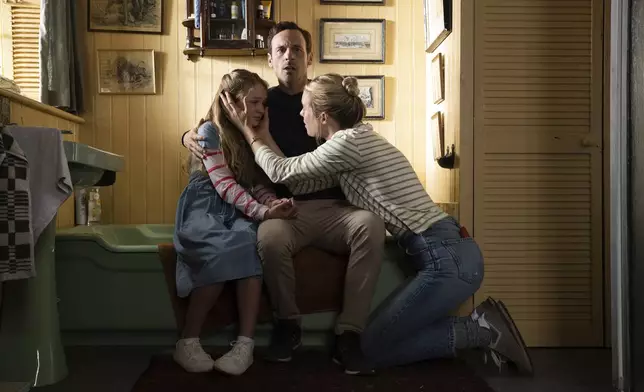 This image released by Universal Pictures shows Alix West Lefler, from left, Scoot McNairy and Mackenzie Davis in a scene from "Speak No Evil." (Universal Pictures via AP)