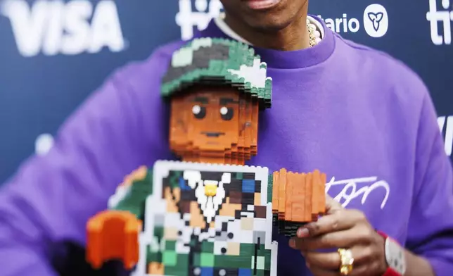 Pharrell Williams arrives on the red carpet for the premiere of 'Piece by Piece' at the Princess of Wales Theatre during the Toronto International Film Festival in Toronto, Tuesday, Sept. 10, 2024. (Cole Burston/The Canadian Press via AP)