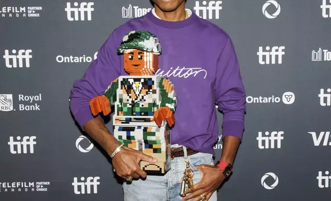 Pharrell Williams arrives on the red carpet for the premiere of 'Piece by Piece' at the Princess of Wales Theatre during the Toronto International Film Festival in Toronto, Tuesday, Sept. 10, 2024. (Cole Burston/The Canadian Press via AP)