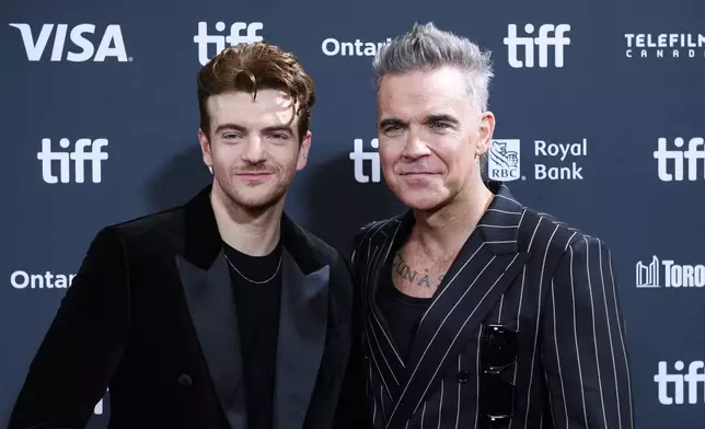 Jonno Davies and Robbie Williams attend the premiere of "Better Man", during the 2024 Toronto International Film Festival, in Toronto on Monday, Sept. 9, 2024. (Christopher Katsarov/The Canadian Press via AP)