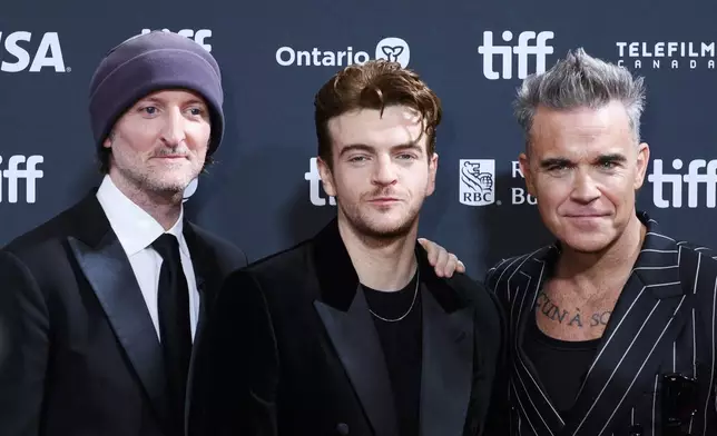 Director Michael Gracey, Jonno Davies and Robbie Williams attend the premiere of "Better Man", during the 2024 Toronto International Film Festival, in Toronto on Monday, Sept. 9, 2024. (Christopher Katsarov/The Canadian Press via AP)