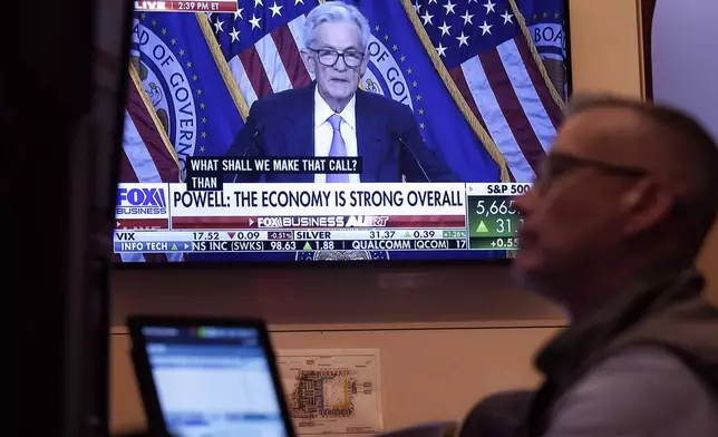 The news conference of Federal' Reserve Chair Jerome Powell appears on a screen as trader Neil Catania works on the floor of the New York Stock Exchange, Wednesday, Sept. 18, 2024. (AP Photo/Richard Drew)