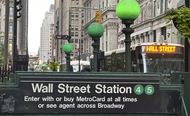 A bus passes the Wall St. subway station on Wednesday, Sept. 18, 2024, in New York. (AP Photo/Peter Morgan)