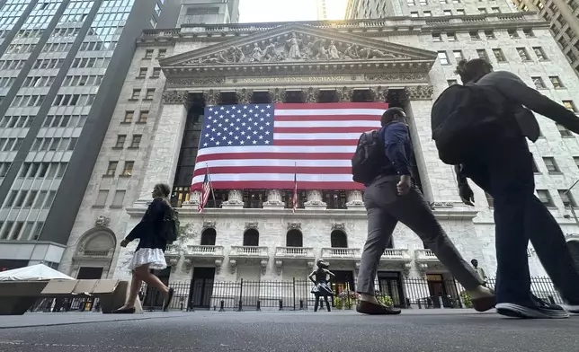 FILE - The American flag hangs from the front of the New York Stock Exchange on Sept. 10, 2024, in New York. (AP Photo/Peter Morgan, File)