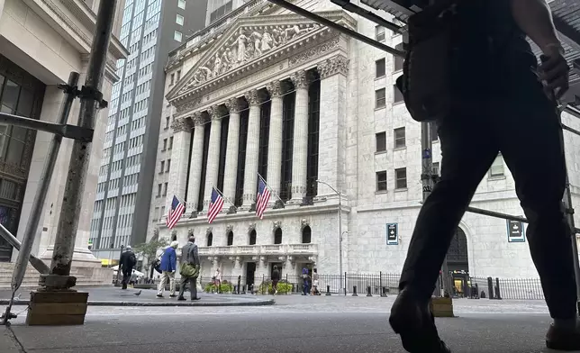 FILE - People pass the New York Stock Exchange on Aug. 27, 2024, in New York. (AP Photo/Peter Morgan, File)