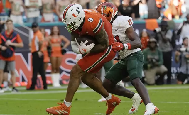 Miami tight end Elijah Arroyo (8) scores a touchdown in front of Florida A&amp;M defensive back Deco Wilson (11) during the first half of an NCAA football game, Saturday, Sept. 7, 2024, in Miami Gardens, Fla. (AP Photo/Lynne Sladky)