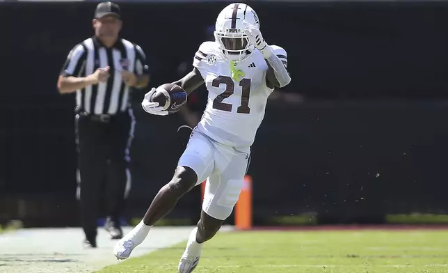 Mississippi State running back Davon Booth (21) runs along the sidelines against Florida during the first half of an NCAA college football game in Starkville, Miss., Saturday, Sept. 21, 2024. (AP Photo/James Pugh)