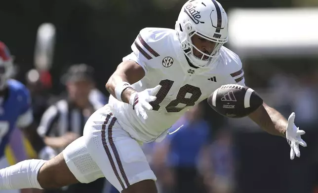 Mississippi State tight end Seydou Traore (18) tries to maintain possession of the ball against Florida during the first half of an NCAA college football game in Starkville, Miss., Saturday, Sept. 21, 2024. (AP Photo/James Pugh)