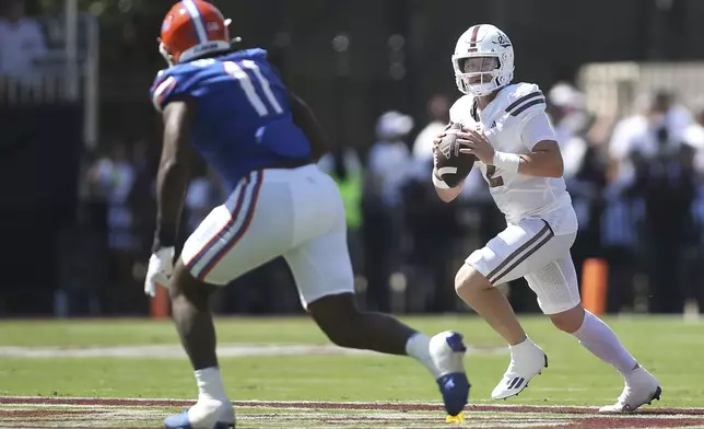 Mississippi State quarterback Blake Shapen (2) looks to pass against Florida defensive end Kelby Collins (11) during the first half of an NCAA college football game in Starkville, Miss., Saturday, Sept. 21, 2024. (AP Photo/James Pugh)