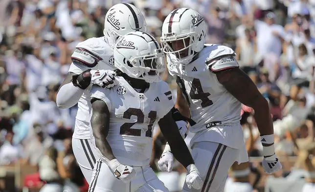 Mississippi State running back Davon Booth (21) celebrates his touchdown run with teammate Mississippi State tight end Justin Ball (84) against Florida during the first half of an NCAA college football game in Starkville, Miss., Saturday, Sept. 21, 2024. (AP Photo/James Pugh)