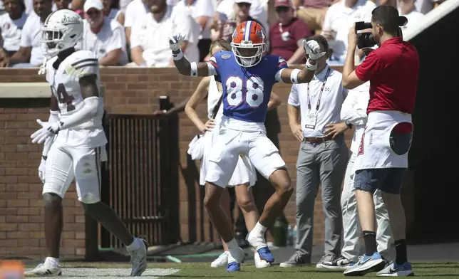 Florida wide receiver Marcus Burke (88) reacts after his touchdown catch against Mississippi State during the first half of an NCAA college football game in Starkville, Miss., Saturday, Sept. 21, 2024. (AP Photo/James Pugh)