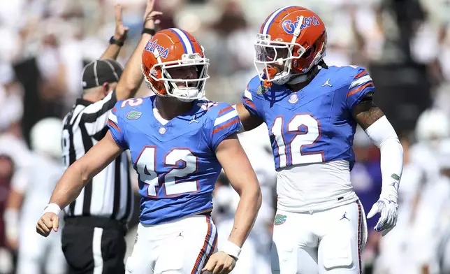 Florida linebacker Matthew Kade (42) and Florida defensive back DJ Douglas (12) react after a play against Mississippi State during the first half of an NCAA college football game in Starkville, Miss., Saturday, Sept. 21, 2024. (AP Photo/James Pugh)