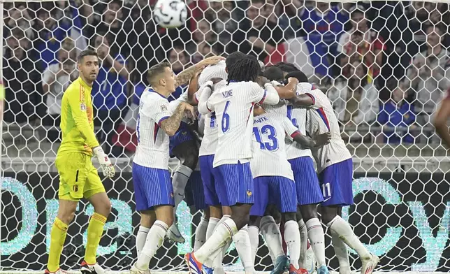 French players celebrate the opening goal of their team during the UEFA Nations League soccer match between France and Belgium at the Groupama stadium in Decines, outside Lyon, France, Monday, Sept. 9, 2024. (AP Photo/Laurent Cipriani)