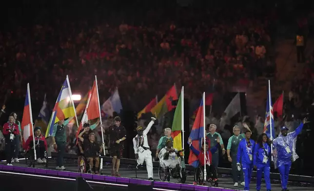 FILE - Athletes from different delegations parade during the closing ceremony of the 2024 Paralympics, Sunday, Sept. 8, 2024, in Paris, France. (AP Photo/Thibault Camus, File)