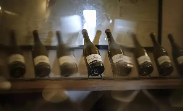 Bottles of Chablis white wine on display at Domaine Lavantureux, in Chablis, Burgundy region, France, Wednesday, Sept. 25, 2024. (AP Photo/Aurelien Morissard)