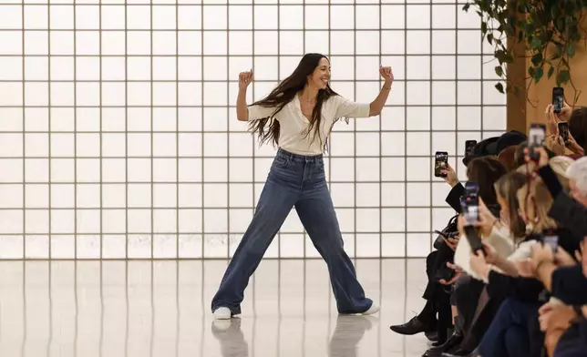 Designer Chemena Kamali accepts applause after the Chloe Spring/Summer 2025 collection presented Thursday, Sept. 26, 2024, in Paris. (Photo by Vianney Le Caer/Invision/AP)