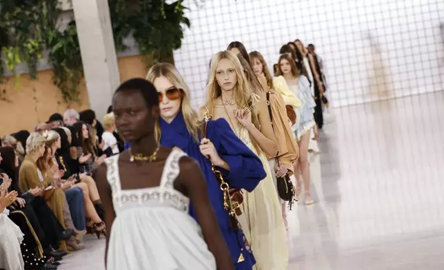 Models wear creations as part of the Chloe Spring/Summer 2025 collection presented Thursday, Sept. 26, 2024, in Paris. (Photo by Vianney Le Caer/Invision/AP)