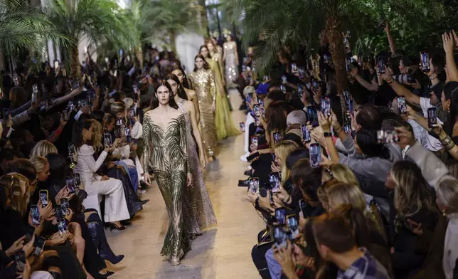 Models wear creations as part of the Elie Saab Spring/Summer 2025 collection presented Saturday, Sept. 28, 2024, in Paris. (Photo by Vianney Le Caer/Invision/AP)