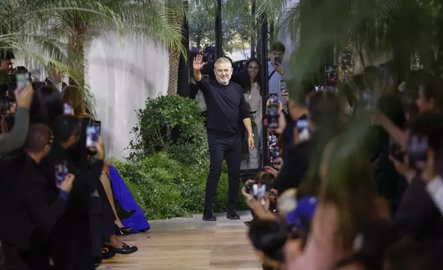 Designer Elie Saab acknowledges applause after his Spring/Summer 2025 collection presented Saturday, Sept. 28, 2024, in Paris. (Photo by Vianney Le Caer/Invision/AP)