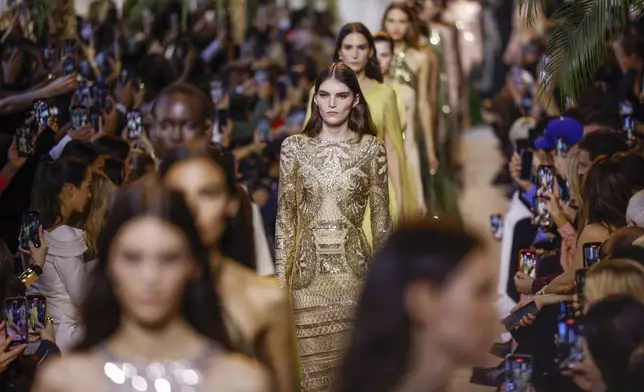 Models wear creations as part of the Elie Saab Spring/Summer 2025 collection presented Saturday, Sept. 28, 2024, in Paris. (Photo by Vianney Le Caer/Invision/AP)