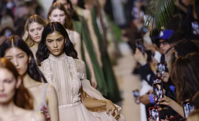 Models wear creations as part of the Elie Saab Spring/Summer 2025 collection presented Saturday, Sept. 28, 2024, in Paris. (Photo by Vianney Le Caer/Invision/AP)