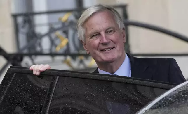 French Prime Minister Michel Barnier boards a car after the first weekly cabinet meeting at the Elysee Palace Monday, Sept. 23, 2024 in Paris. (AP Photo/Christophe Ena)