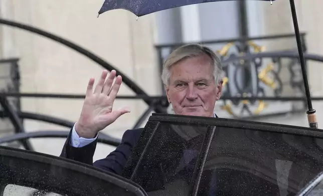 French Prime Minister Michel Barnier boards a car after the first weekly cabinet meeting at the Elysee Palace Monday, Sept. 23, 2024 in Paris. (AP Photo/Christophe Ena)