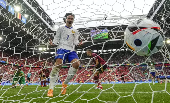 FILE - Antoine Griezmann of France celebrates in the Belgium goal during a round of sixteen match between France and Belgium at the Euro 2024 soccer tournament in Duesseldorf, Germany, Monday, July 1, 2024. (AP Photo/Martin Meissner, File)