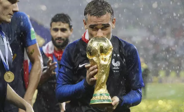 FILE - France's Antoine Griezmann kisses the trophy after the final match between France and Croatia at the 2018 soccer World Cup in the Luzhniki Stadium in Moscow, Russia, Sunday, July 15, 2018. (AP Photo/Matthias Schrader, File)