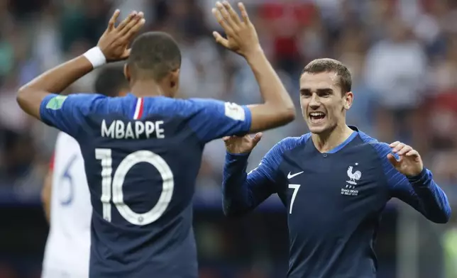 FILE - France's Antoine Griezmann celebrates with his teammate Kylian Mbappe, left, after Paul Pogba scored his side's 3rd goal, during the final match between France and Croatia at the 2018 soccer World Cup in the Luzhniki Stadium in Moscow, Russia, Sunday, July 15, 2018. (AP Photo/Petr David Josek, File)