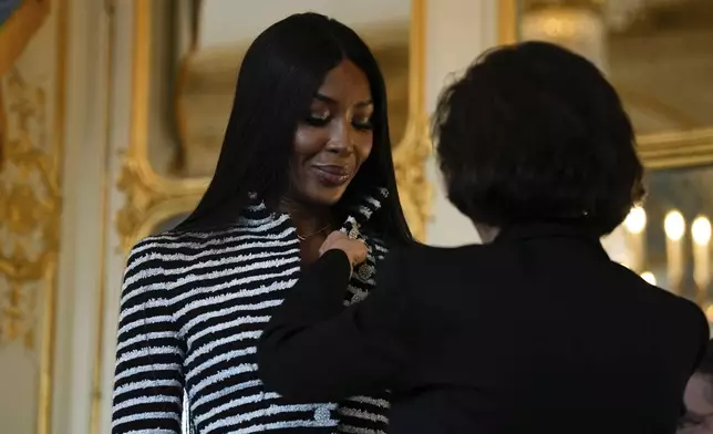 French Culture Minister Rachida Dati, right, awards Naomi Campbell with the medal of "Chevalier de l'Ordres des Arts et des Lettres", at the Culture ministry, in Paris, Thursday, Sept. 26, 2024. (AP Photo/Louise Delmotte)