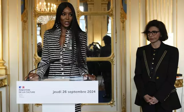 Naomi Campbell delivers a speech after being awarded with the medal of "Chevalier de l'Ordres des Arts et des Lettres", by French Culture Minister Rachida Dati, right, at the Culture ministry, in Paris, Thursday, Sept. 26, 2024. (AP Photo/Louise Delmotte)