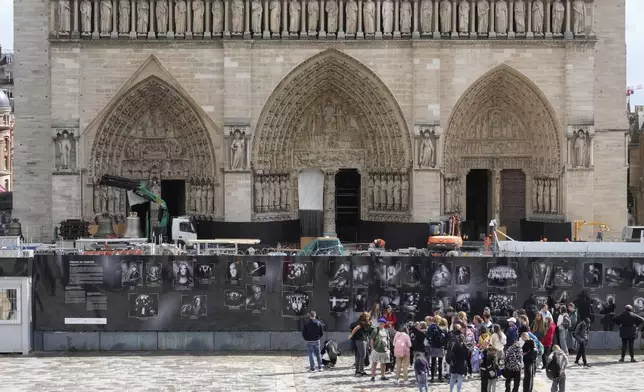 A truck carrying bells, in the background, is parked outside Notre-Dame de Paris cathedral, in Paris, Thursday, Sept. 12, 2024. The Cathedral is getting its bells back, just in time for the medieval landmark's reopening following a devastating 2019 fire. (AP Photo/Michel Euler)