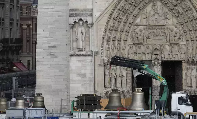 A truck carrying bells is parked outside Notre-Dame de Paris cathedral, in Paris, Thursday, Sept. 12, 2024. The Cathedral is getting its bells back, just in time for the medieval landmark's reopening following a devastating 2019 fire. (AP Photo/Michel Euler)